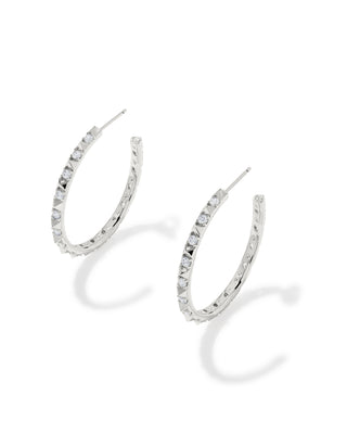 A pair of silver-tone hoop earrings embellished with small clear stones, shown on a clean white background with soft shadows.