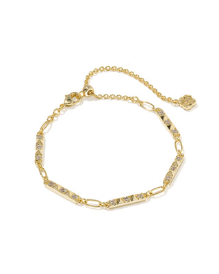 A gold chain bracelet with alternating elongated oval links and triangular links set with clear stones, featuring a lobster clasp and a small decorative charm, shown on a plain white background.