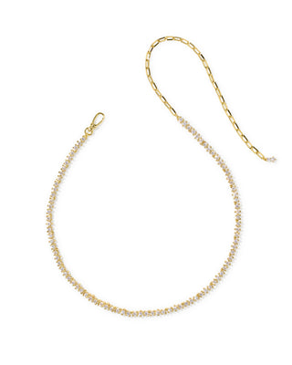 A delicate gold chain necklace featuring a central row of small clear crystals, displayed on a clean white background.