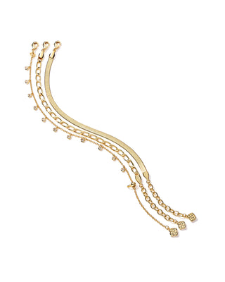 Gold bracelet with chain and small beads on a white background