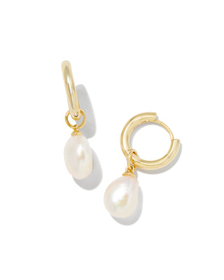 Gold hoop earrings with pearl drops on a white background