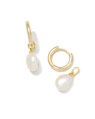 Gold hoop earrings with pearl drops on a white background