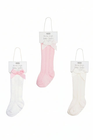 Set of three pairs of baby socks in white and pink on a white background