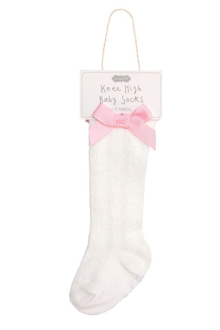 White knee-high baby socks with a pink bow on a white background