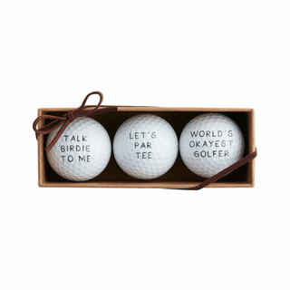 Three golf balls with humorous text in a box on a white background