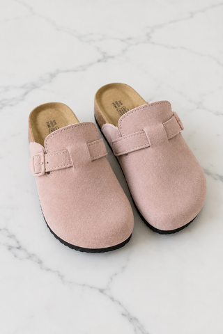 Light pink suede potato shoes on white marble background