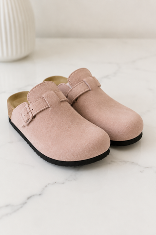 Light pink suede potato shoes on white marble background