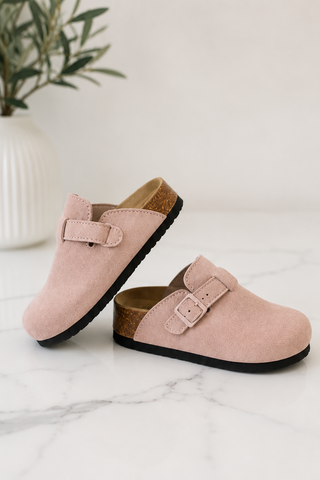 Light pink suede potato shoes on white marble background