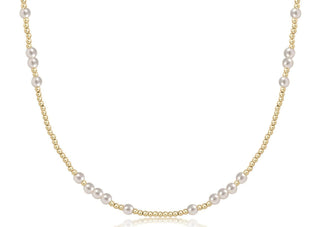 Pearl necklace with gold chain on a white background
