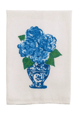 White towel with blue floral design on a white background