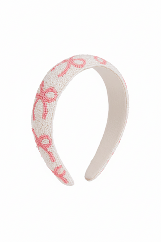 Headband with pink bow pattern on a white background