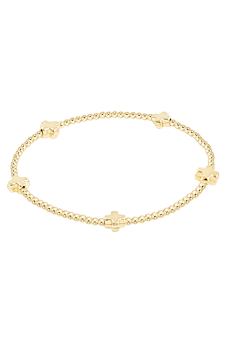 Gold bracelet with small decorative elements on a white background