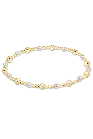 Gold and pearl bracelet on a white background