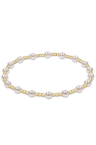 Pearl bracelet with gold accents on a white background