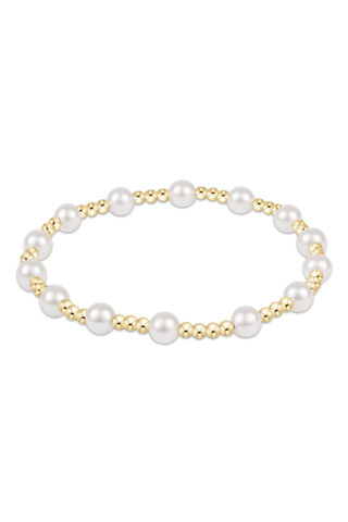 Pearl bracelet with gold accents on a white background