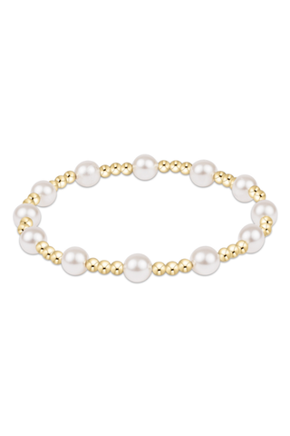 Pearl and gold beaded bracelet on a white background