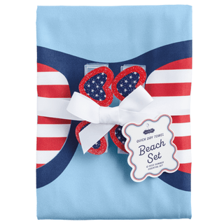 Folded towel with American flag design and decorative elements on a light blue background
