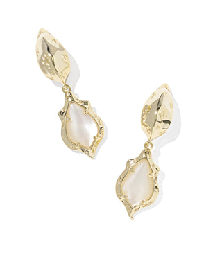 Gold earrings with white stones on a white background