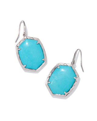 Turquoise earrings with silver hooks on a white background